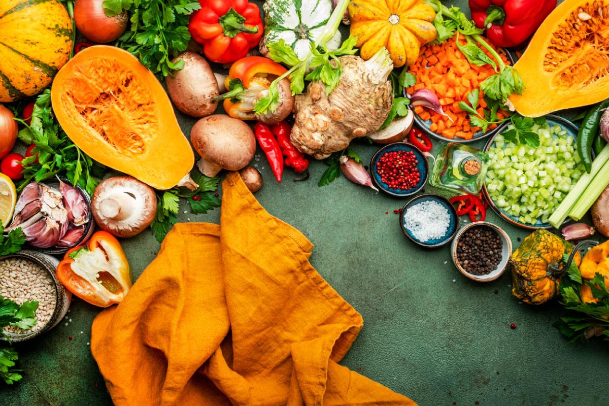 Collection of vegetables, mushrooms, squash, chopped onions and a napkin.